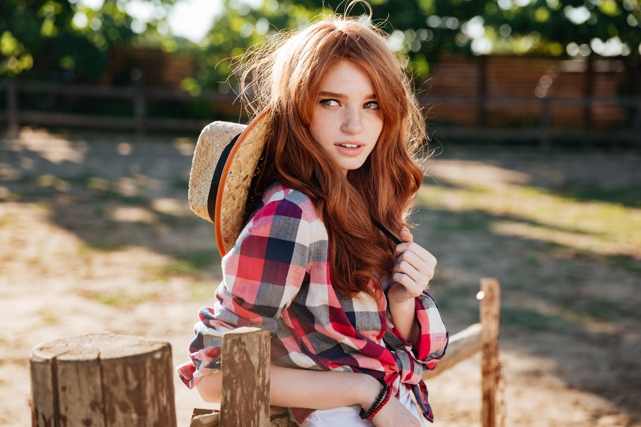 Attractive Redhead Young Woman Cowgirl Standing Outdoors